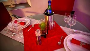 a bottle of wine sitting on a table with wine glasses at Spielzimmer am Bodensee in Rorschach