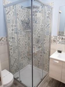 a bathroom with a shower with a toilet and a sink at Casacecilia relax in Siracusa