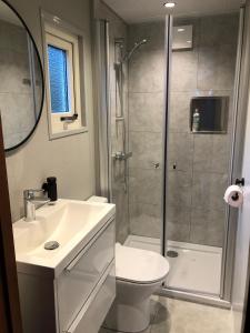 a bathroom with a shower and a toilet and a sink at Vakantiepark Kijkduin - 884 in The Hague