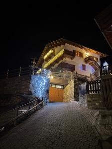 a building with lights on it at night at Residence Fior di Roccia in Campodolcino