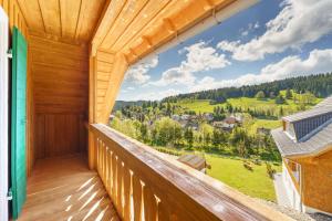 a view from the balcony of a wooden house at Hotel Schlehdorn in Feldberg