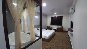 Postel nebo postele na pokoji v ubytování Hotel Jurkis, Kolhapur