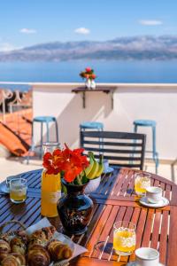 a table with food and flowers on top of a balcony at Villa Opera Garden in Sutivan