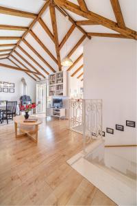 a living room with wooden ceilings and a table at Villa Opera Garden in Sutivan