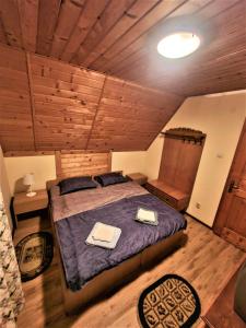 a bedroom with a bed with two towels on it at Vila Luca's in Cârțișoara