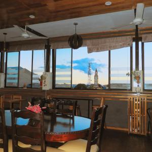 a dining room with a table and a view of the clock tower at Casa Nativa Iquitos in Iquitos