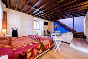 una camera con un grande letto e un soggiorno di Avalon Boutique Suites Hotel a Città di Rodi