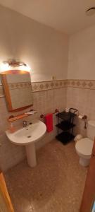 a bathroom with a sink and a toilet at El Mijares in Olba