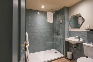 a bathroom with a shower and a sink at Castle Inn in West Lulworth