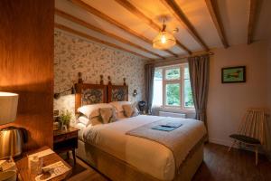 a bedroom with a large bed and a window at Castle Inn in West Lulworth