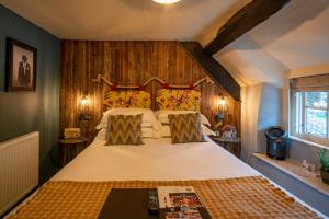 a bedroom with a large bed with wooden walls at Castle Inn in West Lulworth