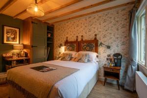 a bedroom with a bed in a room with wallpaper at Castle Inn in West Lulworth