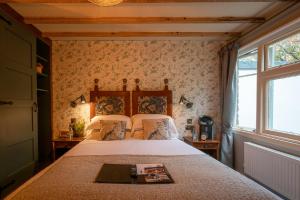 a bedroom with a bed with a book on it at Castle Inn in West Lulworth