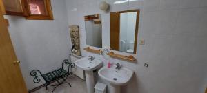 a white bathroom with a sink and a mirror at El Mijares in Olba