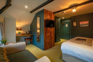 a hotel room with a bed and a desk at Castle Inn in West Lulworth