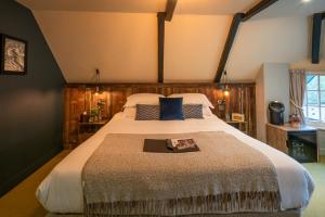 a bedroom with a large bed in a room at Castle Inn in West Lulworth
