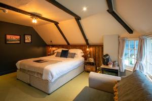 a bedroom with a large bed and a couch at Castle Inn in West Lulworth
