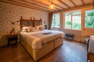 a bedroom with a large bed in a room at Castle Inn in West Lulworth