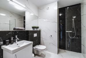 W łazience znajduje się umywalka i prysznic. w obiekcie Emihouse Skyline Apartments w mieście Rzeszów