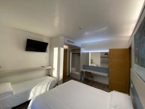 a hotel room with two beds and a mirror at Casa Nostra in Selva del Montello