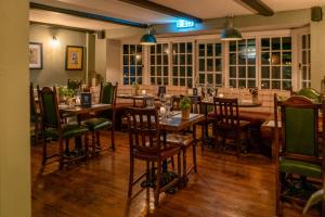 a restaurant with tables and chairs in a room at Castle Inn in West Lulworth