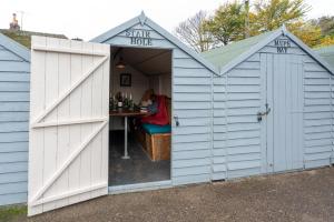 a white shed with a table in it at Castle Inn in West Lulworth