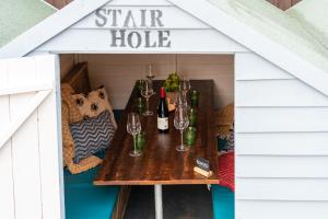 a table in a play house with wine glasses at Castle Inn in West Lulworth