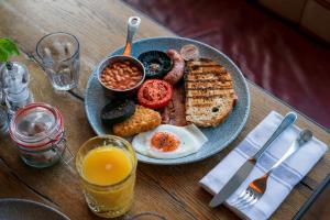 a plate of breakfast food on a wooden table at Castle Inn in West Lulworth