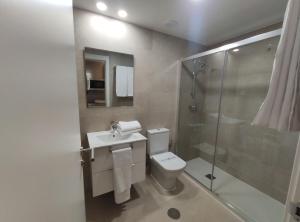 y baño con aseo, lavabo y ducha. en Apartamentos Atempo Aranjuez, en Aranjuez