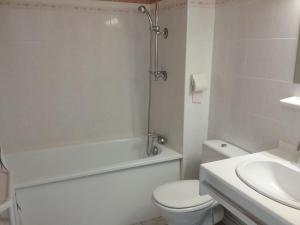 a white bathroom with a toilet and a sink at Gravezon in Lunas +25 photos