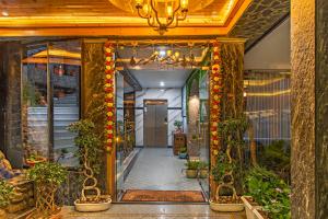 an entrance to a building with plants and a chandelier at Kanishka Retreat Resort Chail in Chail