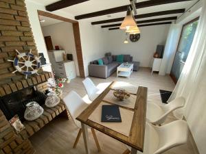 a living room with a wooden table and chairs at Sonneneck 2 in Brodersby