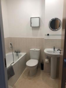 a bathroom with a toilet and a sink at Chichester Holiday Lets in Chichester