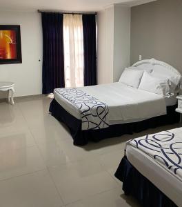 Postel nebo postele na pokoji v ubytování Hotel Suite Santa Rosa