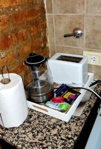 a kitchen counter with a coffee maker and a toaster at Duplex Boulevard D in Viedma