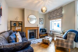 a living room with a couch and a fireplace at Maggie's Place in York