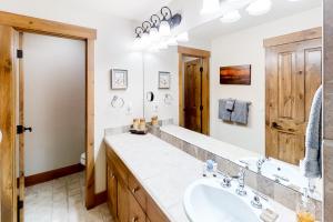 a bathroom with a sink and a mirror at Mountain Sky in Granby +45 photos