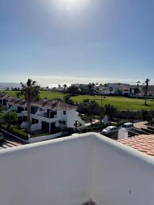 a view of the ocean from the balcony of a house at Fairways Club in San Miguel de Abona