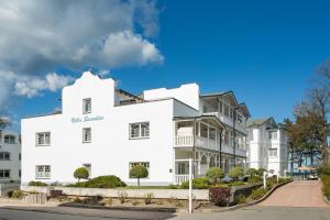 um edifício branco com um sinal na lateral em Strandvilla Seeadler hinter Düne und Meer em Binz