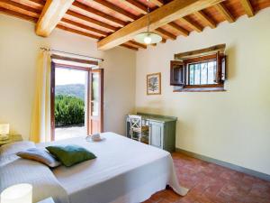a bedroom with a bed and a large window at Locanda del Viandante - Valle Apartments & Pool in Anghiari