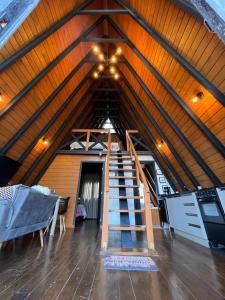 a room with a staircase in a attic at URUBICI - Cabana da Montanha in Mundo Novo