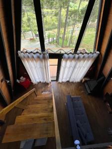 two white curtains on the stairs in a cabin at URUBICI - Cabana da Montanha in Mundo Novo