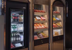 a refrigerator filled with lots of drinks and food at TITANIC Comfort Kurfürstendamm in Berlin