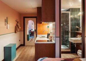 a bathroom with a sink and a shower at room2 Chiswick Hometel in London