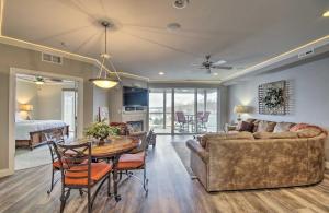 a living room with a couch and a table at Top-Floor Lands End Corner Unit with Resort Perks! in Osage Beach