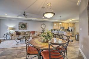 a living room and kitchen with a table and chairs at Top-Floor Lands End Corner Unit with Resort Perks! in Osage Beach