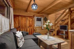 a living room with a couch and a table at Domki u Ciaptoka in Zakopane