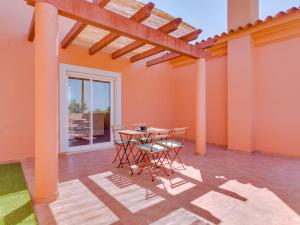 a patio with a table and chairs in a room at Vilamoura ZEN Garden, private 3bdr vila with pool in Vilamoura