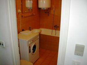 a bathroom with a sink and a washing machine at Apartment Old Town in Pula