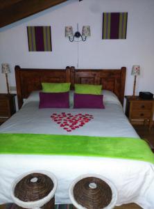 a bedroom with a bed with a heart on it at La Fuente in Umbrías